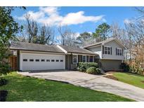 Charming home with a two-car garage, beautifully landscaped front yard, and inviting curb appeal at 260 Mansell Cir, Roswell, GA 30075