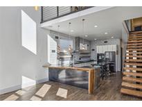 Modern kitchen features a large island, stainless steel appliances, and an open layout with wood floors at 560 John Wesley Dobbs Ave, Atlanta, GA 30312
