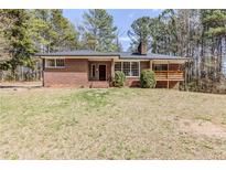 Charming brick home featuring a well-maintained lawn and inviting front entrance at 3435 Macland Rd, Powder Springs, GA 30127
