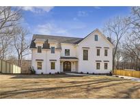 Beautiful two-story modern farmhouse featuring a large front yard and dark shingle roof at 510 Forest St, Buford, GA 30518