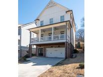 Charming home features a covered porch, two-car garage and a well-maintained exterior at 140 Rigby Ne St, Marietta, GA 30060