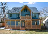 Stunning two-story home with a modern facade, inviting porch, and impeccable architectural details at 561 Ashburton Ave, Decatur, GA 30032