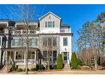 Beautiful three-story townhouse with brick and siding, a balcony, and a well-maintained front lawn at 101 Meeting St, Alpharetta, GA 30009