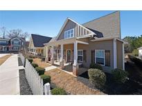 Charming home with a covered front porch, decorative shutters, and a manicured lawn at 207 Tan Yard Rd, Social Circle, GA 30025