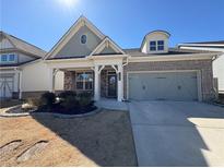Charming brick home with a two-car garage and a well-manicured front yard at 2628 Songbird Ln, Grayson, GA 30017