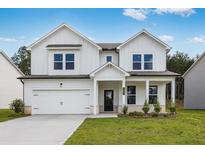 Charming two-story home boasts a modern design, manicured lawn, and inviting front porch at 205 Groveton Ct, Euharlee, GA 30145