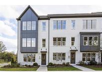 Charming townhome exterior with modern design and manicured front lawn and welcoming front door at 2453 Red Maple Se Xing # 118, Smyrna, GA 30080