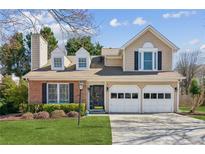 Charming two-story home features a brick facade, two-car garage, and a well-maintained lawn at 2989 Abbotts Oak Way, Duluth, GA 30097