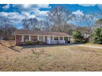 Charming brick home with a well-maintained lawn and inviting front porch at 11 Grove Ln, Hampton, GA 30228