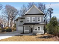 Charming gray two-story home with a welcoming front porch and well-manicured lawn at 2150 Essex Sw Ave, Atlanta, GA 30311