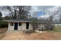 Single-story home featuring a brick facade and a dark roof at 2317 Sheryl Dr, Decatur, GA 30032