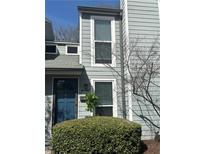 Two story home featuring a dark blue front door and light grey siding at 1063 Riverbend Club Se Dr, Atlanta, GA 30339