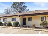 Inviting exterior with manicured bushes, neutral paint, and marked parking spots at 803 New Horizon St, Powder Springs, GA 30127