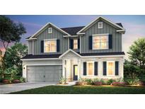 Charming two-story home featuring gray siding, dark shutters, and a well-manicured lawn at 1654 Tide Mill Rd, Cumming, GA 30040
