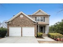 Charming two-story home featuring a stacked stone front and a two car garage at 665 Sable View Ln, Atlanta, GA 30349
