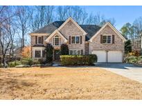 Charming two-story brick home with a well-manicured lawn and a two-car garage at 6119 Fairlong Nw Run, Acworth, GA 30101