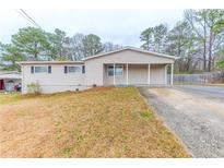 Charming one-story home featuring a covered porch and well-maintained front yard at 6202 Humphries Hill Rd, Austell, GA 30106