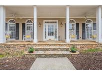 Charming front porch featuring rocking chairs, stone accents, and a welcoming entrance, great for relaxing outdoors at 6360 Brookline Ct, Cumming, GA 30040