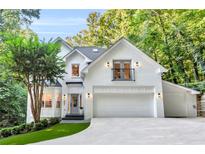Stunning two-story white brick home with well-manicured landscaping and a private balcony at 3882 The Ascent Ne, Brookhaven, GA 30319