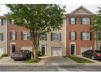 Charming brick and siding townhouse with a one-car garage and manicured front yard at 5381 Briar Creek Ln, Norcross, GA 30071