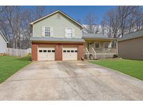 Charming two-story home with a brick garage and spacious driveway, set on a well-maintained lot at 618 Jenmarie Sw Dr, Mableton, GA 30126