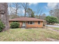 Charming single-story brick home with a mature tree in the front yard at 1844 Buckeye Sw St, Atlanta, GA 30310