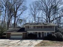 Traditional two-story home with a brick and siding exterior and attached two-car garage at 4617 N Peachtree Rd, Dunwoody, GA 30338
