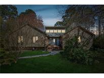 Charming single-Gathering home with lush green lawn, beautiful stone walkway and eye-catching architectural details at 10015 Timberstone Rd, Alpharetta, GA 30022