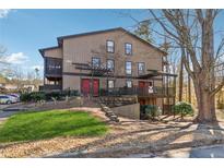 Two-story exterior with a small front yard and pergola covered walkways at 408 River Run Dr, Atlanta, GA 30350