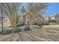 Charming brick home with a well-manicured lawn and mature landscaping creating inviting curb appeal at 2836 Springrock Way, Lawrenceville, GA 30043