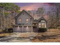 Charming two-story home with a three-car garage and well-maintained landscaping in a wooded setting at 146 Crowell Se Rd, Conyers, GA 30094