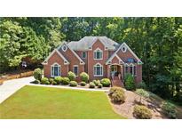 Beautiful two-story brick home featuring manicured landscaping and a well-maintained lawn at 2287 Lake Ridge Ter, Lawrenceville, GA 30043