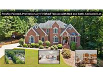 Stately brick home featuring mature landscaping and a freshly painted terrace at 2287 Lake Ridge Ter, Lawrenceville, GA 30043
