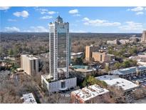 Stunning aerial view of a modern high-rise condominium with a beautiful cityscape backdrop on a sunny day at 2828 Peachtree Nw Rd # 1402, Atlanta, GA 30305