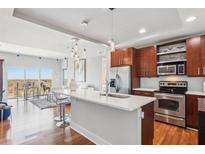 Modern kitchen with stainless steel appliances and a spacious island with a marble countertop at 4561 Olde Perimeter Way # 2609, Atlanta, GA 30346
