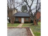 Charming brick home featuring a well-maintained lawn and mature trees in a tranquil neighborhood setting at 4762 Old Highgate Entry, Stone Mountain, GA 30083