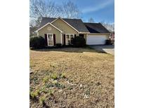 Charming single-story home with well-maintained lawn and attached two-car garage at 413 Chippewa Se Dr, Acworth, GA 30102
