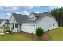 Charming new construction home featuring a light gray exterior, well-manicured lawn, and an attached two-car garage at 1649 Tielman Way, Snellville, GA 30078