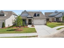 Charming single-Gathering home featuring a manicured lawn, inviting entrance and attached two car garage at 1629 Tielman Way, Snellville, GA 30078