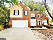 Charming two-story home with a brick facade, a two-car garage, and mature trees in a well-maintained neighborhood at 120 Croftwood Ct, Johns Creek, GA 30097