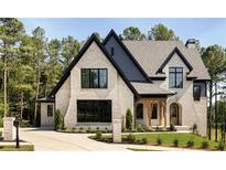 Stunning two-story brick home with manicured lawn and black trim at 6055 Tattnall Overlook, Acworth, GA 30101