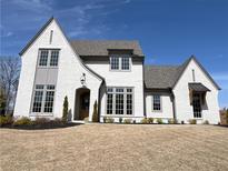 Beautiful two-story home with painted brick, covered porch, and manicured front yard at 64 Telfair Ct, Acworth, GA 30101