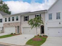 A modern townhome row featuring attached garages and manicured landscaping at 747 Trevett Way, Marietta, GA 30062