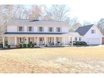 Charming two-story home with a welcoming front porch and beautifully landscaped yard at 762 Thompson Ln, Loganville, GA 30052
