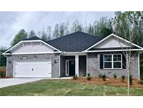 Charming brick home featuring a two-car garage, landscaped front yard, and covered entrance at 113 Scarlett Place Dr, Bowdon, GA 30108