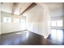 Bright dining area featuring wood beams, wainscoting, and dark hardwood flooring at 2076 Greenridge Se Rd, Smyrna, GA 30080