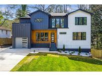 Modern two-story home with a gray and white exterior and well-manicured lawn at 2949 Laguna Dr, Decatur, GA 30032