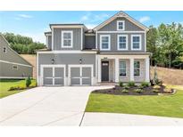 Charming two-story home featuring a two-car garage, stone accents, and a well-manicured front lawn at 333 Willow Cv, Canton, GA 30114