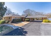Charming single-story home with a large driveway and covered parking area at 952 Northside Dr, Lawrenceville, GA 30043