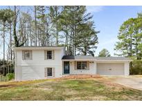 Charming home featuring a brick and white siding exterior with an attached two-car garage and inviting curb appeal at 151 Wilbur Ln, Lawrenceville, GA 30044